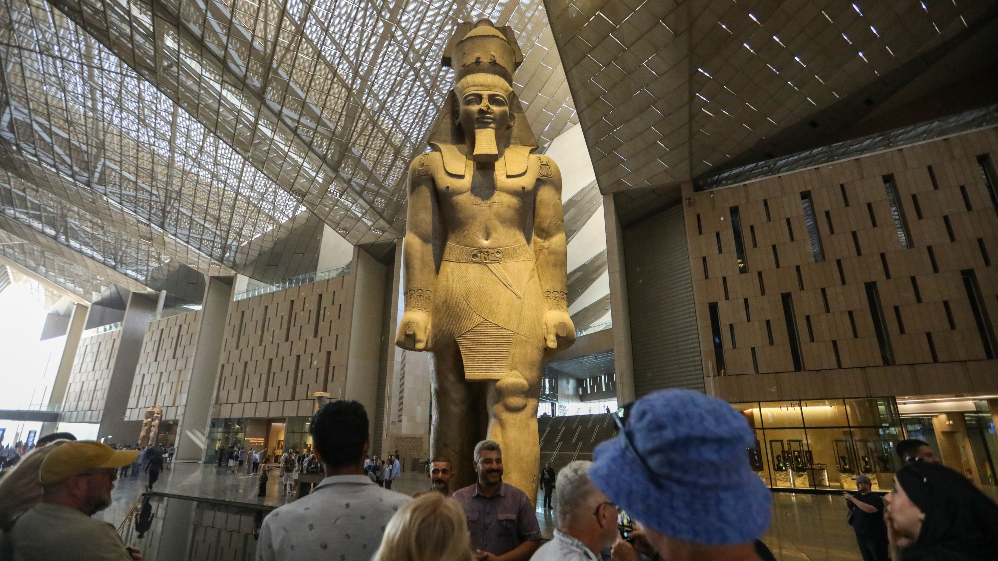 Crowd of visitors at the Grand Egyptian Museum in Giza, Egypt in front of a 30ft-tall statue of Ramses II, dating to around 1200BC