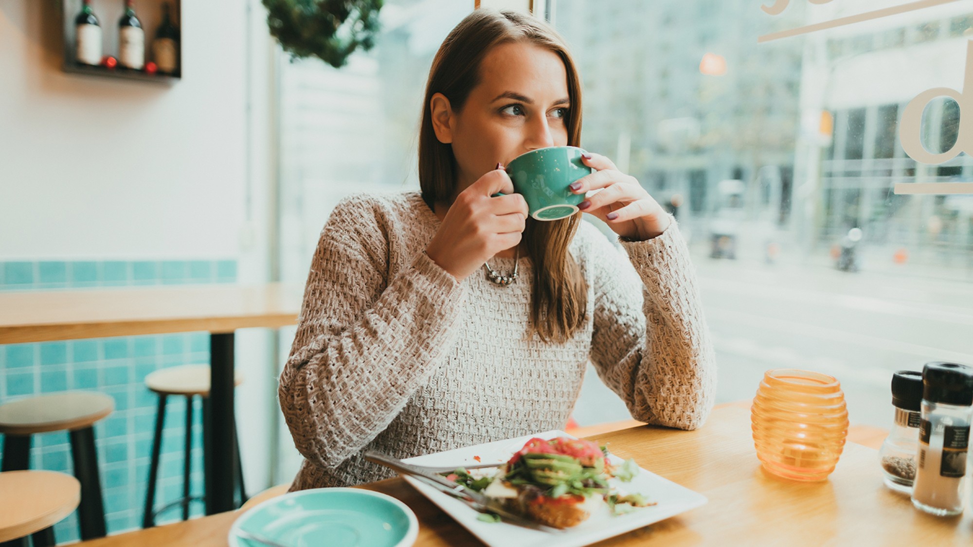 Woman happily eating in a restaurant alone