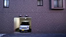A Japanese kei or micro car sits in a garage in Sapporo, Japan.