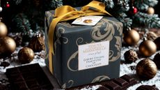 packaged in a navy blue box with a gold ribbon - Chocolate Panettone by DukesHill